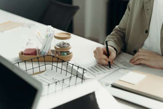 A woman writing at her desk