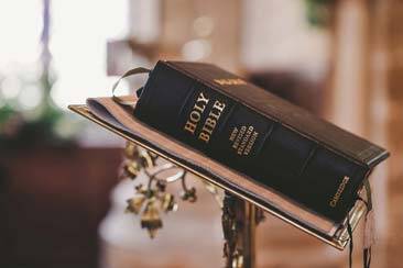 Holy Bible, New Revised Standard Edition on the podium as Bible forms the foundation of Seventh Day Adventist Church - AAAF