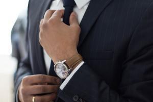 Man Straightening Tie Dressing up in your best attire to attend Adventist Church on Sabbath morning