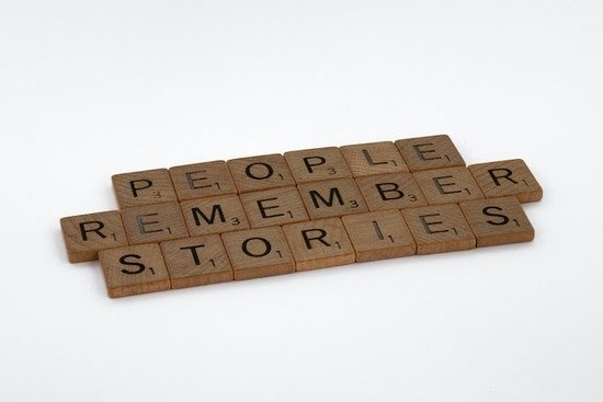 wooden tiles that say people remember stories