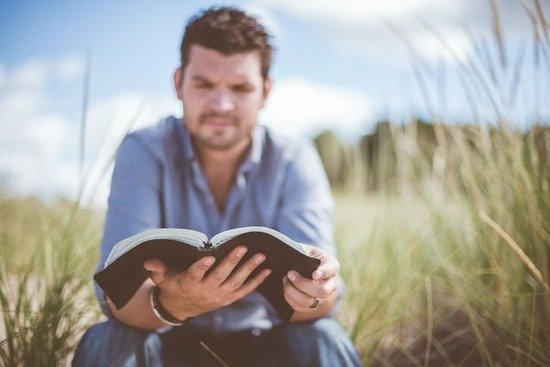 A man reading the Bible to gain strength from God against temptation