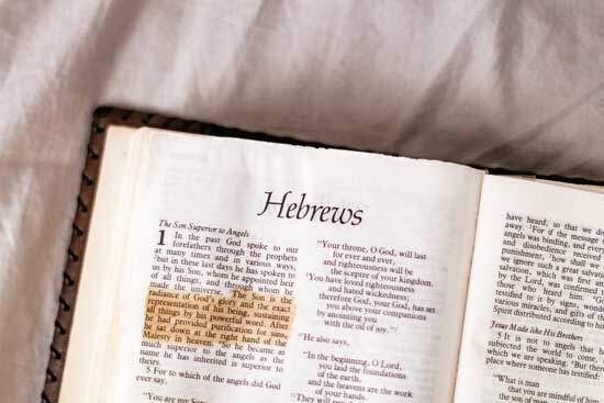A Bible open to Hebrews, a book of the Bible that talks about Jesus being the one who made the worlds