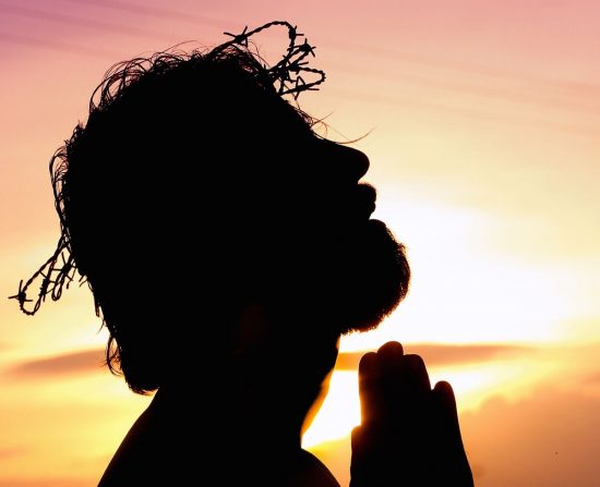 Silhouette of Jesus Christ with a crown of thorns on His head as He came to conquer evil