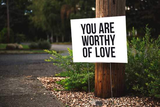 Board displaying "You are Worthy of Love" pointing to the Scriptures teaching that God is a God of love & worthy of our love