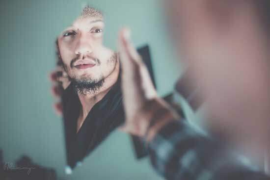 Man looking in a mirror A man looking at himself in a mirror, just like God's Law reveals our sin and points us to Christ