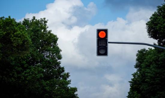 A red traffic light that is on a pole A red traffic light illustrates how God's law functions to warn us to act accordingly.