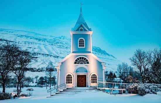 Adventist Church near a snow-covered mountain as we learn what Seventh Day Adventists believe about the Church