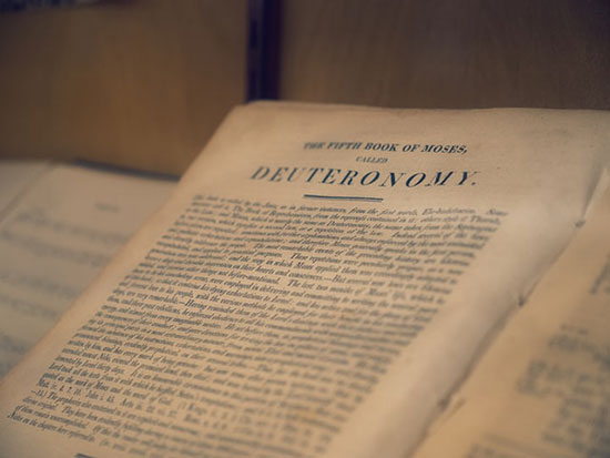 Book of Deuteronomy Bible open in the book of Deuteronomy as we learn that this book with 34 chapters reinforces God's covenant with His people.