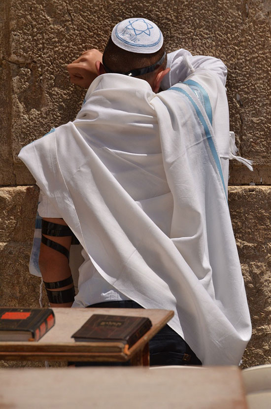 A Jew praying on the wailing wall at Jerusalem as Sabbath begins