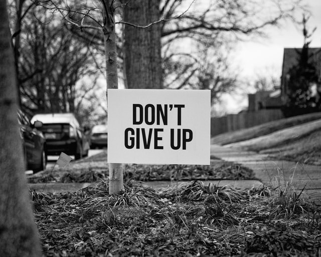 Sign board of Don't Give Up as we learn to be helpful because God is faithful and He has plans to give us hope and future.
