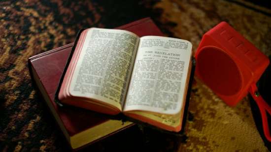 A Bible open to the book of Revelation, written by the prophet John
