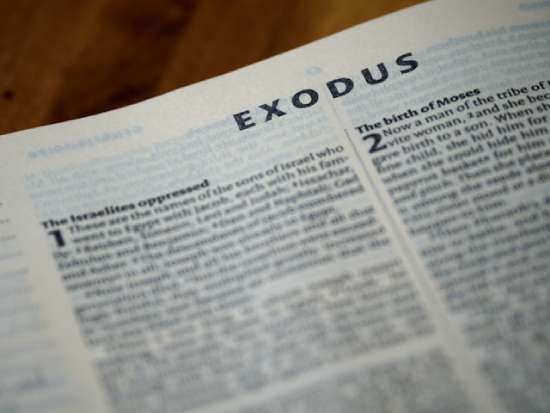 A Bible open to the first page of the book of Exodus
