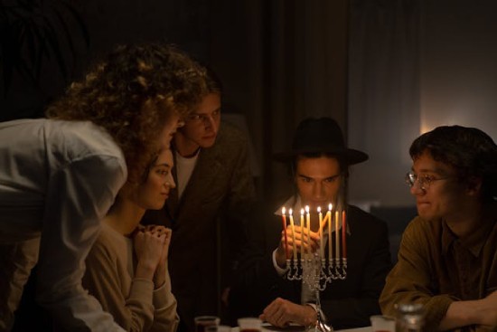Modern day Jews lighting menorah candles as part of their Sabbath observance Modern day Jews lighting menorah candles as part of their Sabbath observance