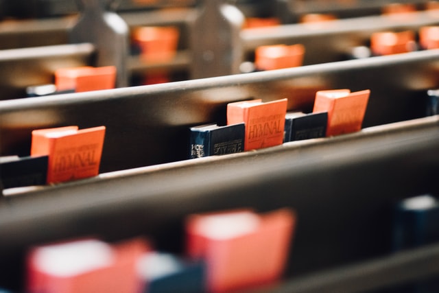 Hymnals resting in the backs of pews at an Adventist Church