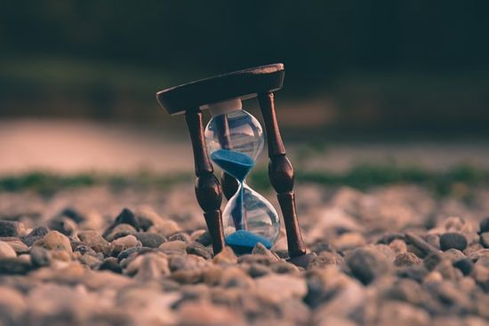  Hourglass on ground as we learn how God's timing is not our timing and we must wait upon Him and put our faith on His timing.