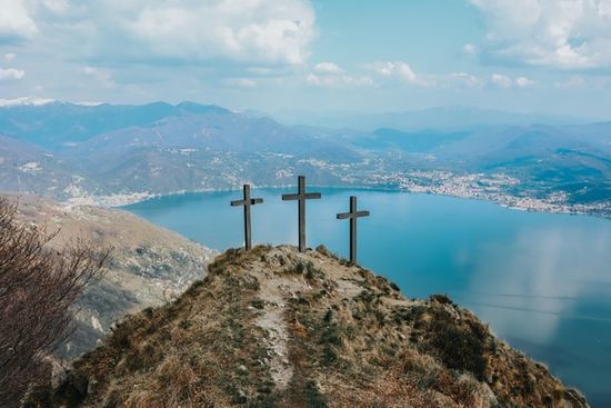 Three crosses on a hill overlooking a lake which represent God's provision of Jesus Christ as a sacrifice