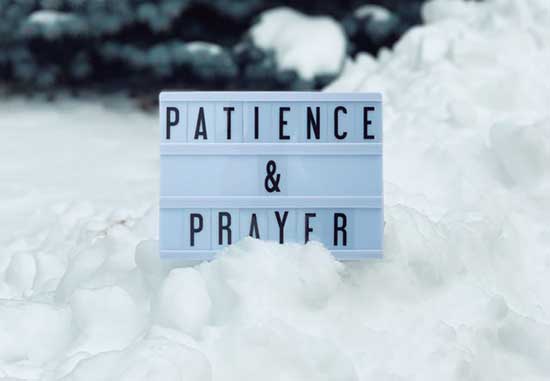 A white sign with the words patience and prayer