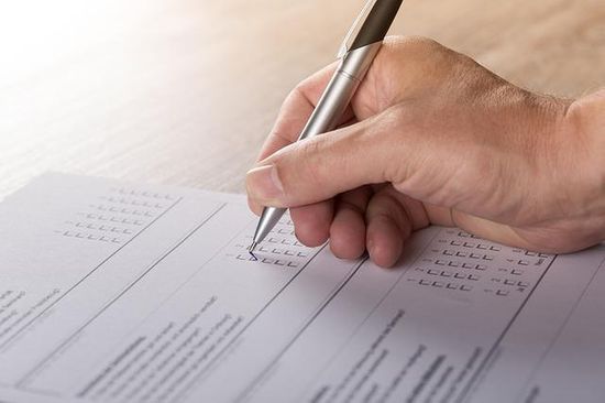 Adventist Health Study Questionnaire Someone checks off a box on a questionnaire.