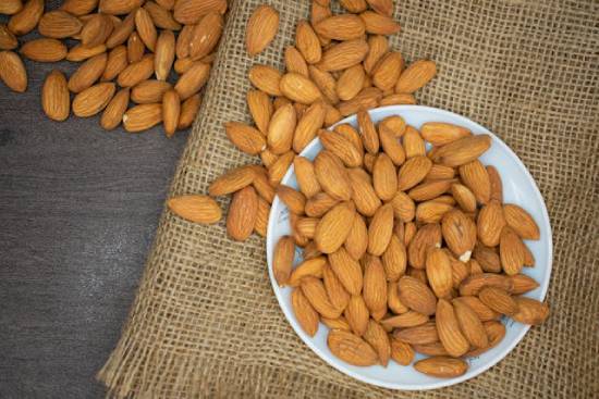 Almonds on a plate A plate of overflowing almonds.