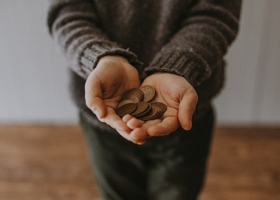 Hands holding coins