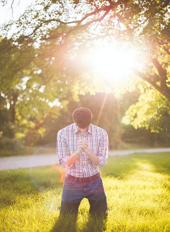 A man under a tree praying to God