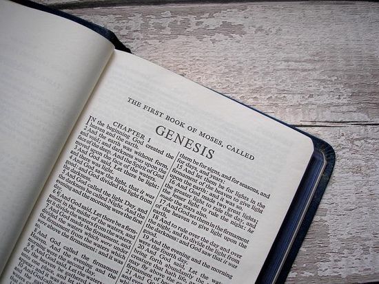 A Bible open to the first book of the Old Testament, Genesis