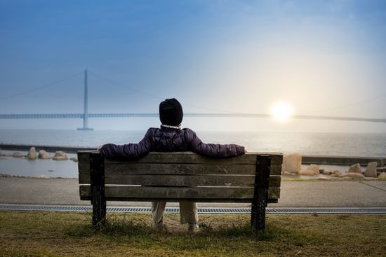 A person resting on a bench for the Sabbath, taking in God's creation.