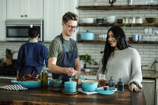 A man and woman teaching a cooking class for an evangelistic meeting