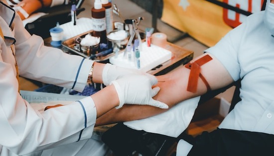 Adventist Nurse Drawing Blood A lab nurse drawing the blood of a patient at an Adventist medical center