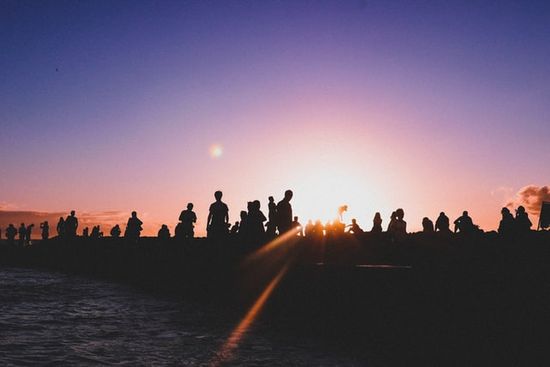 A gathering of Christians at the beach at sunset