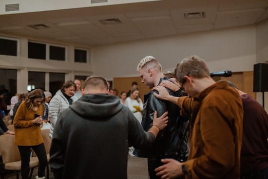 A group of colporteur evangelists gathering together to pray for one another