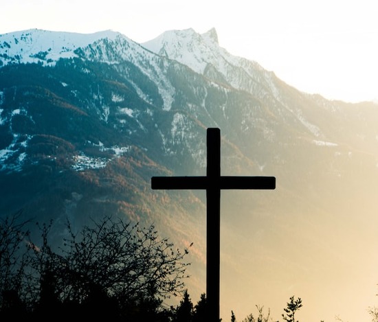 A cross near a mountain, symbolizing the death of Jesus Christ to pay the penalty of sin