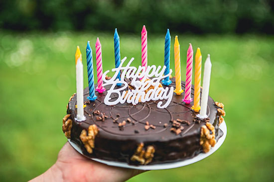 A chocolate cake with candles for an Adventist birthday celebration