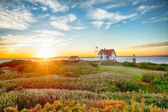 A house on a hilltop with a sunrise in the background, reminding us of how Christians are to be lights on a hill