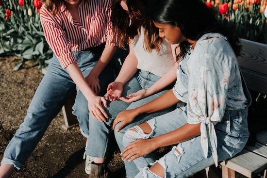 Three friends gathered together in intercessory prayer