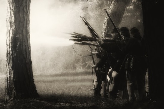 Soldiers with rifles reenacting the Civil War of the nineteenth century