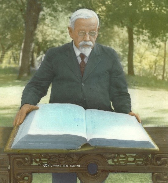 A man with his hands on a big family Bible