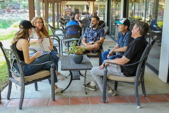 A small group sitting on a patio and discussing God's Word