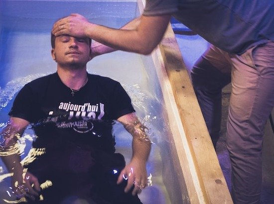 A man being baptized by immersion