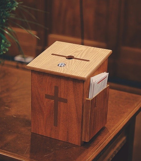 A wooden offering and tithe collection box at a Seventh-day Adventist Church