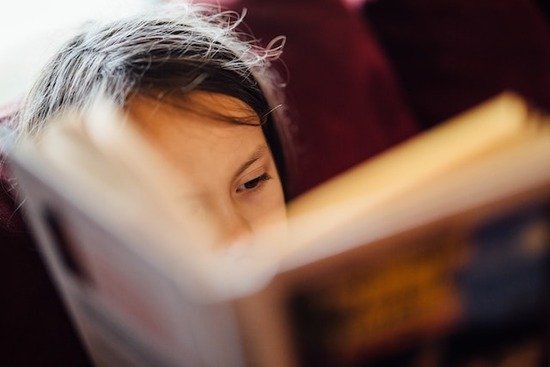 A child reading, just like J. N. Andrews taught himself