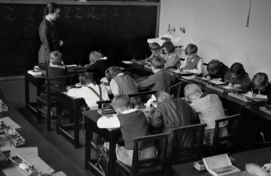 A teacher and her classroom of students in 1935