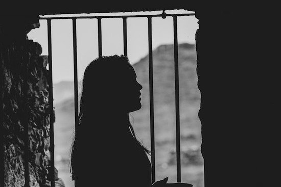 A woman behind bars for her faith in God