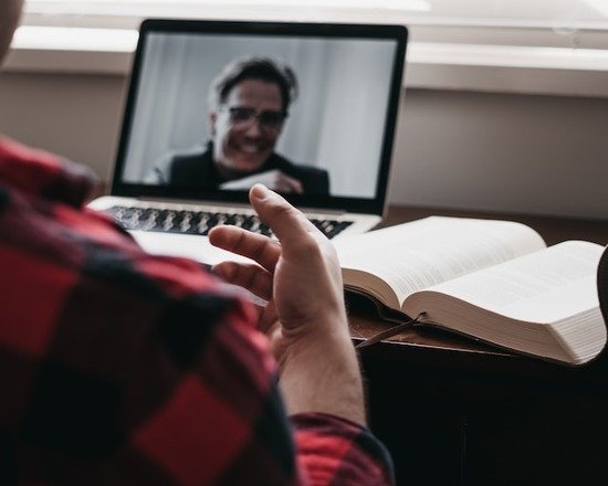 A person having a virtual Bible study on a laptop
