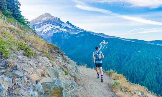 A man running in the mountains, living out the health counsels of Ellen White for the Adventist Church