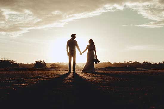 A silhouette of a Christian couple holding hands