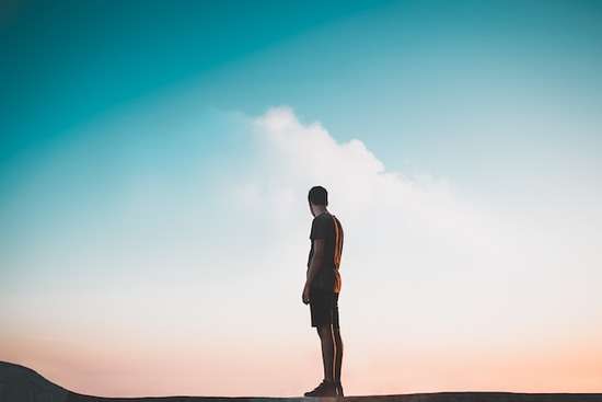 man with head bowed in prayer for God's forgiveness