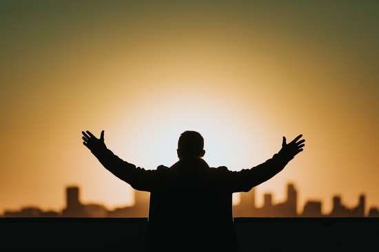 man with head bowed in prayer for God's forgiveness