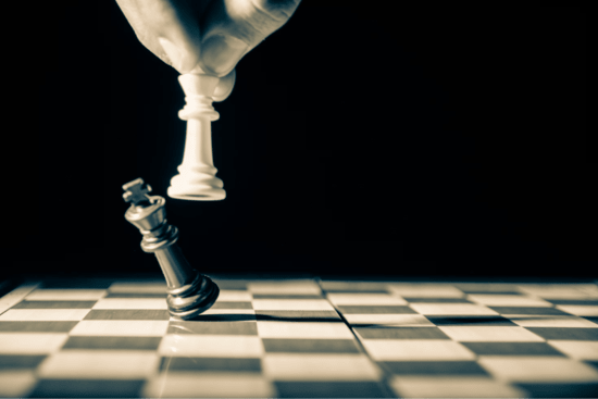 Chess pieces defeating each other, representing conflict