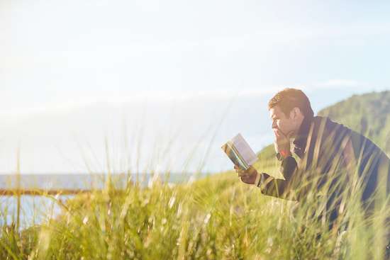 A man reading his Bible to find principles for resolving conflict